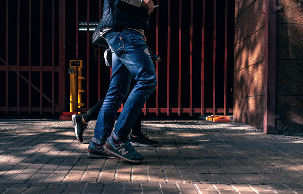 Person Walking Beside Another Person Outside