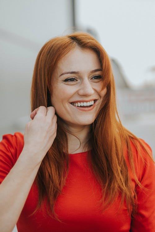 Portrait of Laughing Redhead Woman in Red Dress · Free Stock Photo