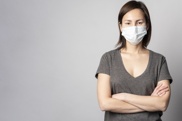 Portrait of woman posing with surgical mask Free Photo