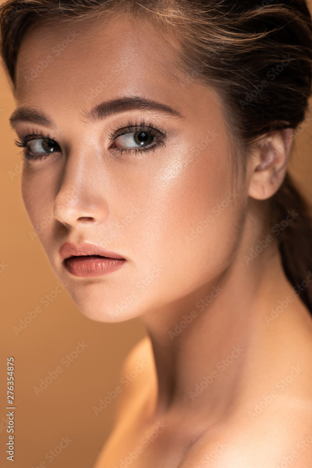 Free: portrait of young beautiful naked woman with shiny makeup isolated on beige - nohat.cc