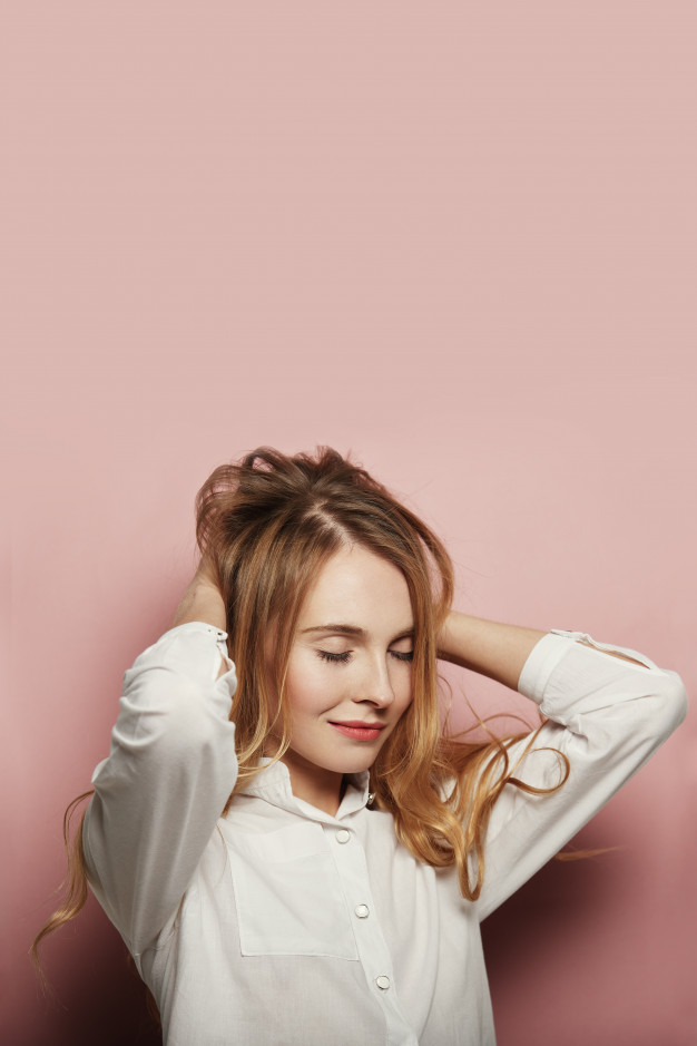 Pretty young woman posing on pink background Free Photo