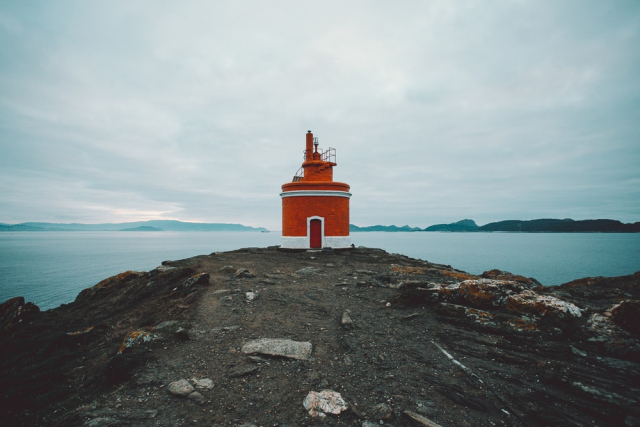 Red and White Lighthouse on Cliff
