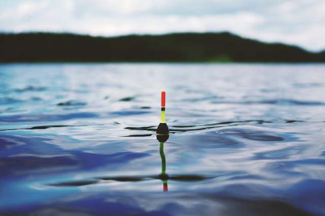 Red Yellow and Black Bouy on Body of Water during Daytime