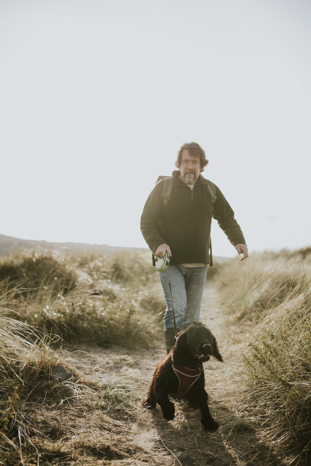Senior man walking his dog | Free Photo - rawpixel