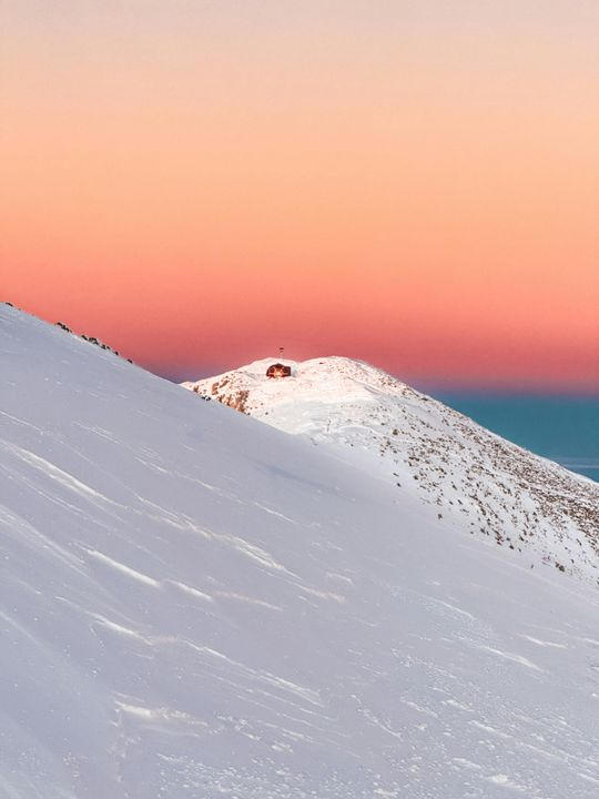 Serene Snow-Covered Mountain Landscape at Dusk