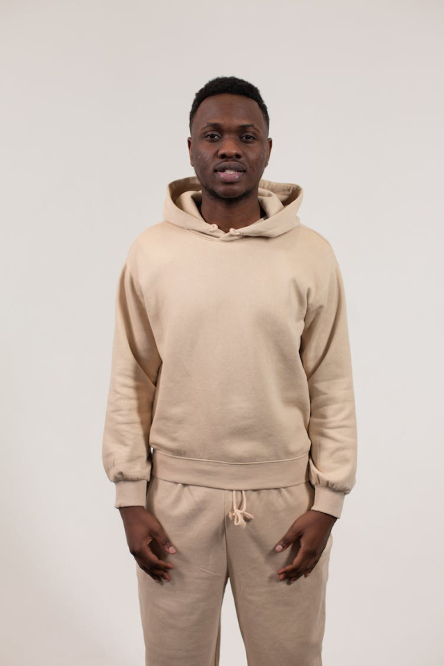 Serious black man in hoodie in studio