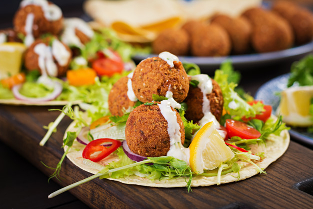 Tortilla wrap with falafel and fresh salad. vegan tacos. vegetarian healthy food. Free Photo