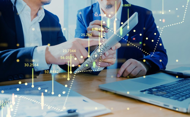 Two Businessmen Utilizing Digital Tablet To Discuss Financial And Marketing Solutions With Financial Chart State Blended In Effect Photo