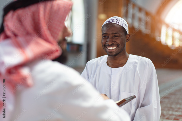 Two religious muslim man praying together inside the mosque