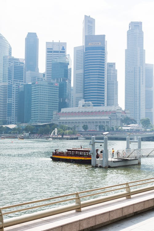 Yellow and Red Boat Across City Building · Free Stock Photo