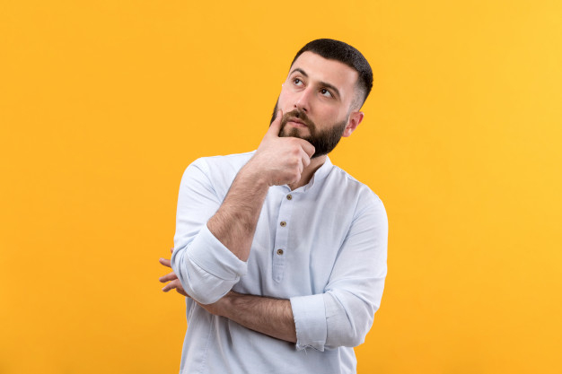 Young man in white shirt with beard thinking expression Free Photo