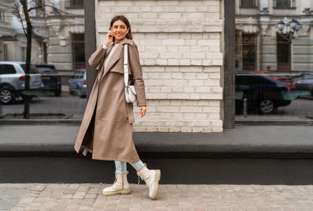 Young woman wearing a leather trench-coat